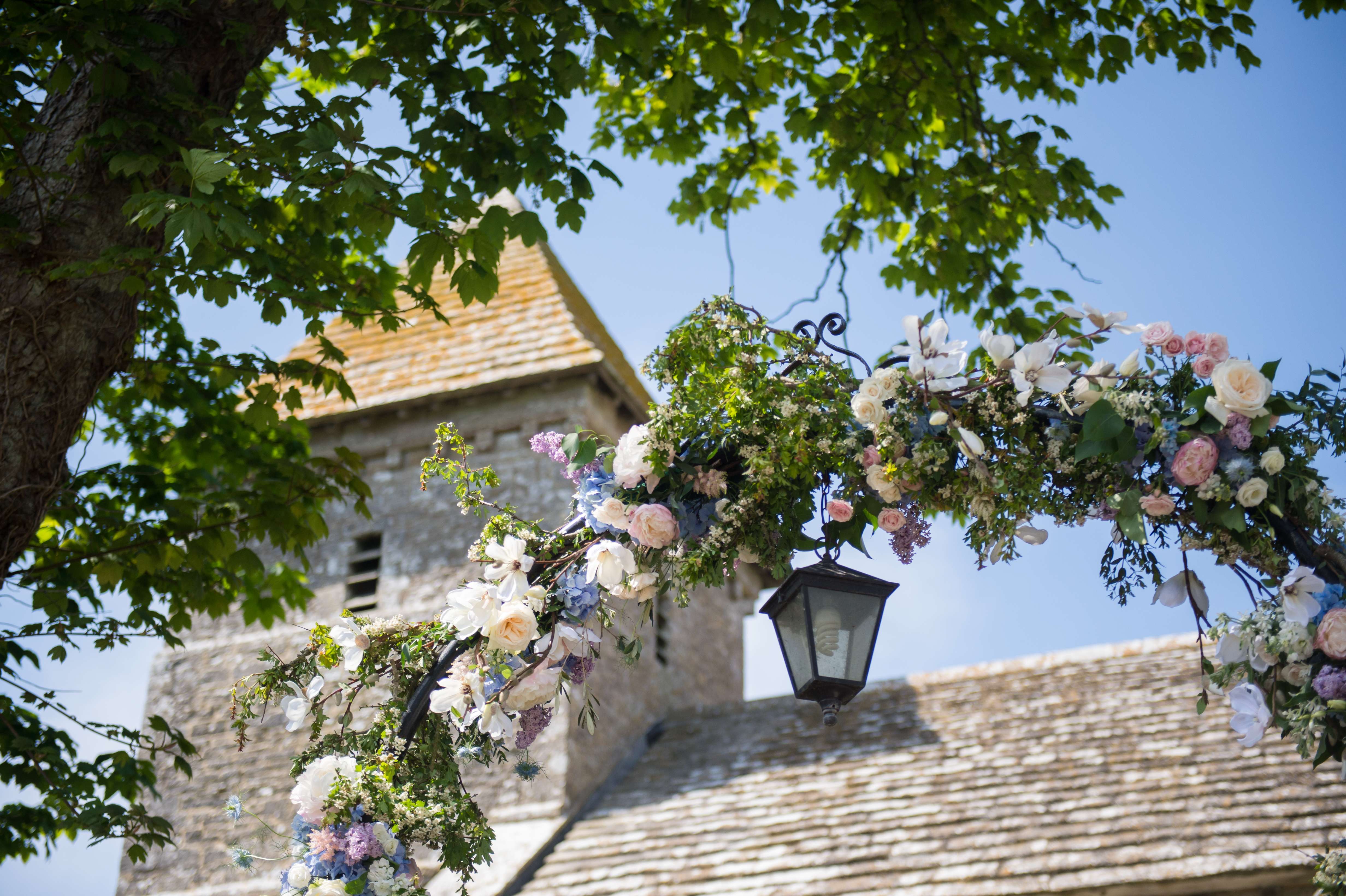 rose arch at a church in dorset by flowers by passion florist